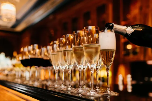 Glasses of champagne being filled on the bar