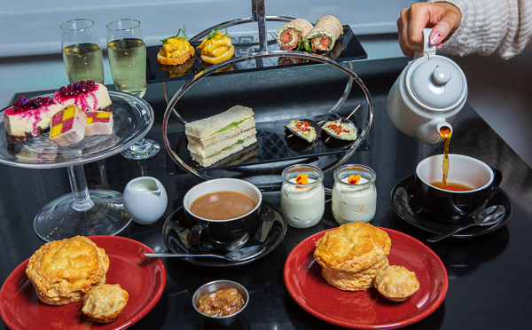Afternoon Tea spread with tea being poured at The Crown at Woodbridge