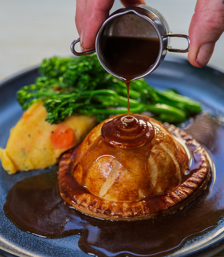 Pithivier pie - gravy pour at The Crown at Woodbridge
