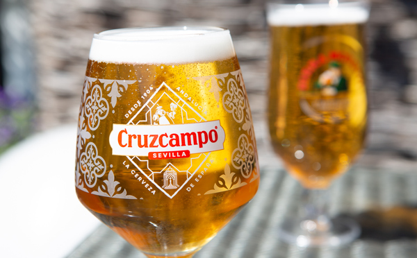 Pint of Birra Moretti and Cruzcampo beer on terrace table in the sunshine