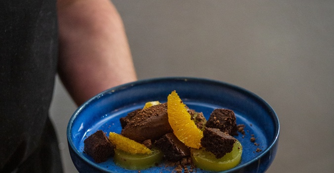 The Crown Flavours of Jaffa Cake Sponge, orange jelly, mousse Close up Held By Chef